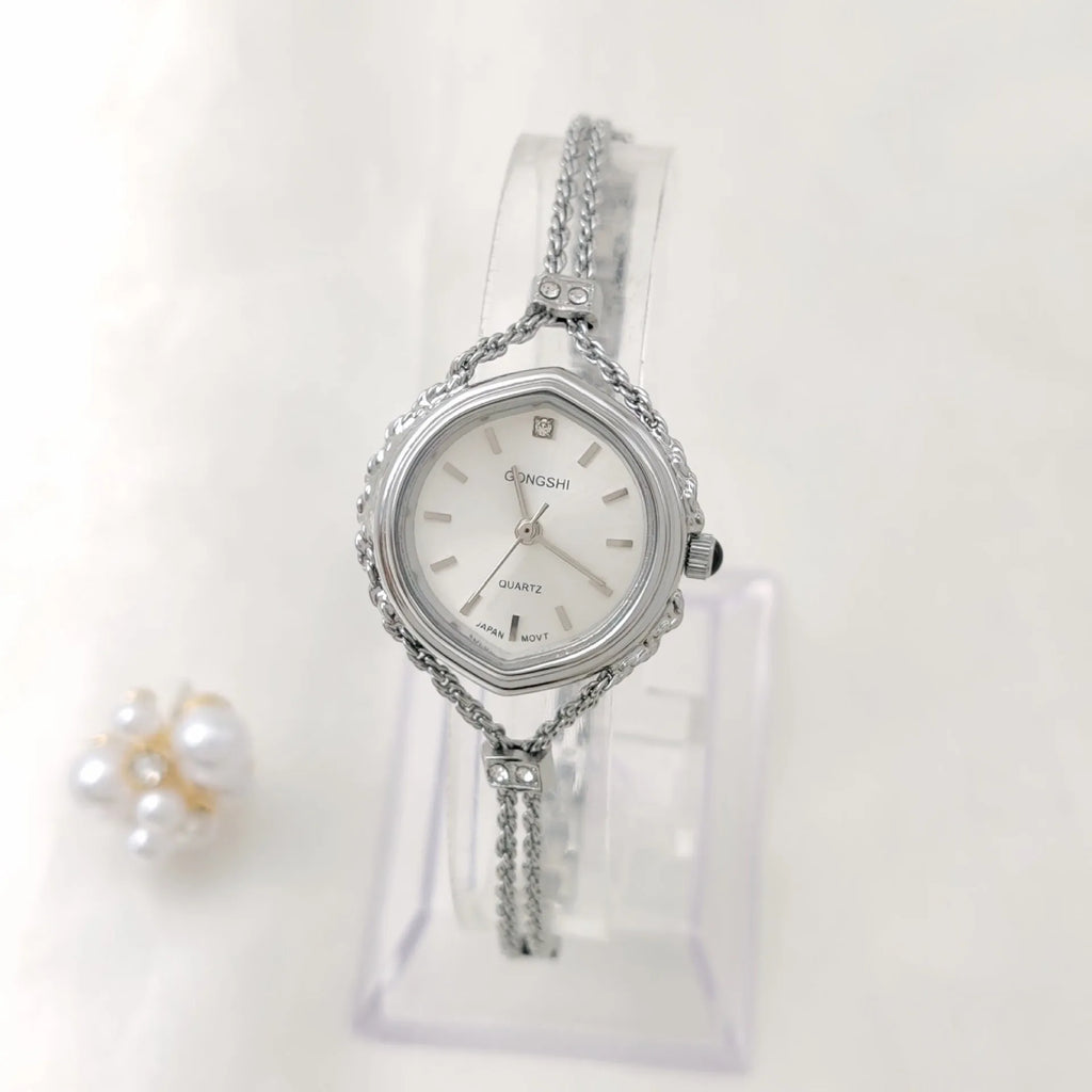 Gold or silver Mori-style women's quartz watch with a 25mm dial and metal chain strap.