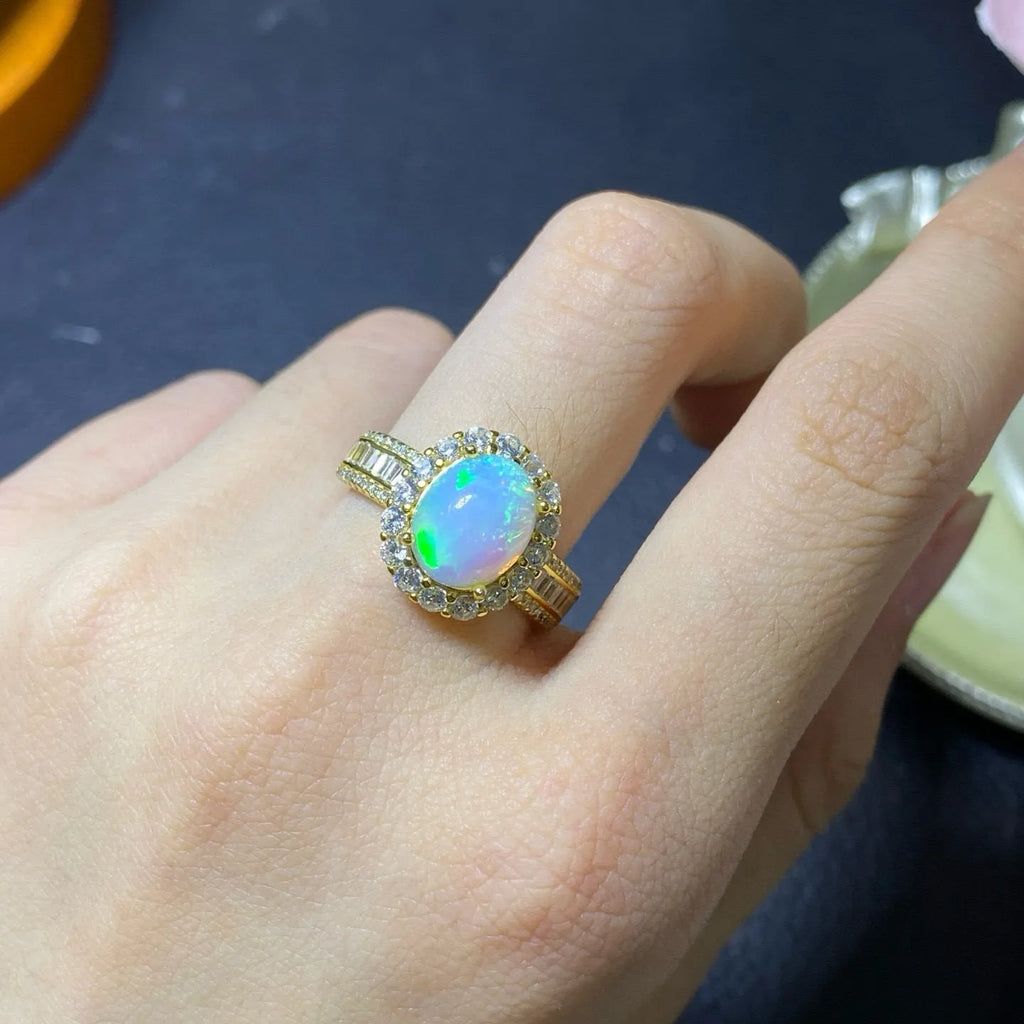 Handmade adjustable silver ring with a natural opal stone in rose gold plating.