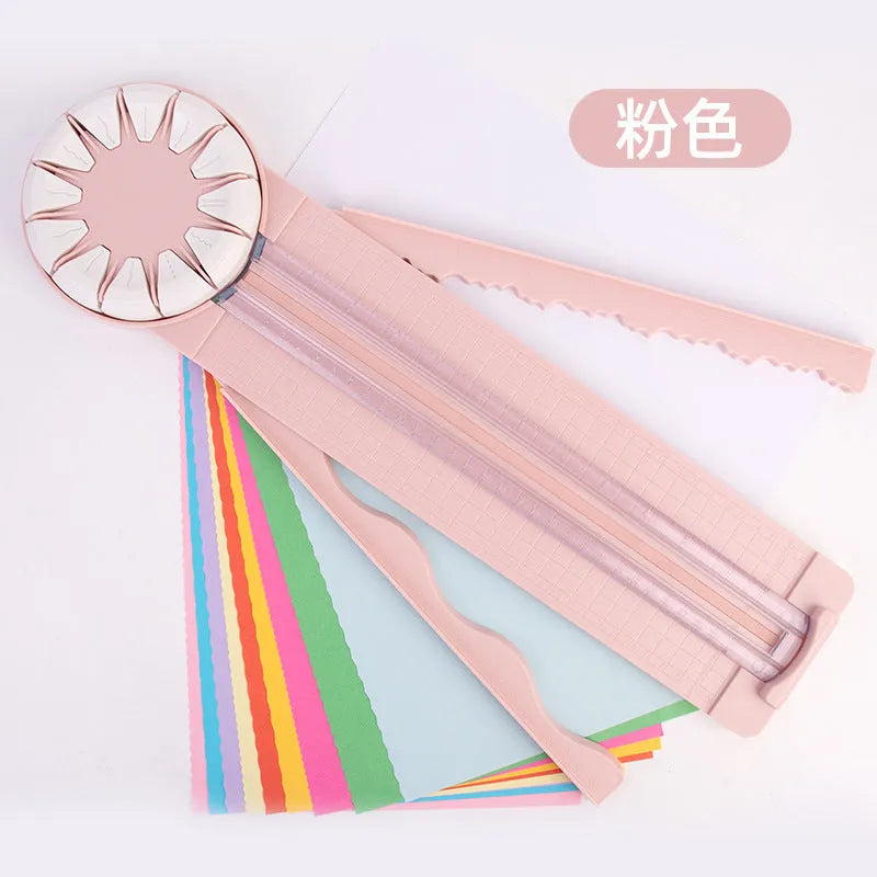 Pink and black 12-in-1 manual plastic paper cutting machine on a white background.