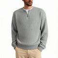 Men's loose grey half zipper textured knit sweater on a hanger.