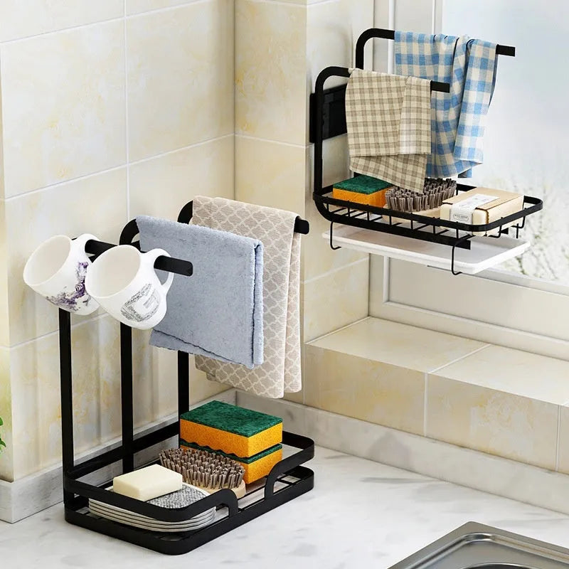 Foldable white plastic kitchen rack for wall mounting or desktop use, holding a sponge and cloth.