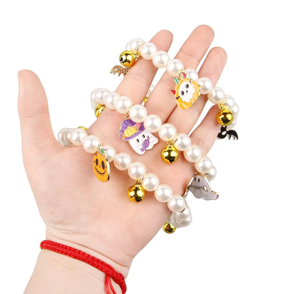 Simulated pearl necklace pet collar decoration with a pumpkin charm for Halloween.