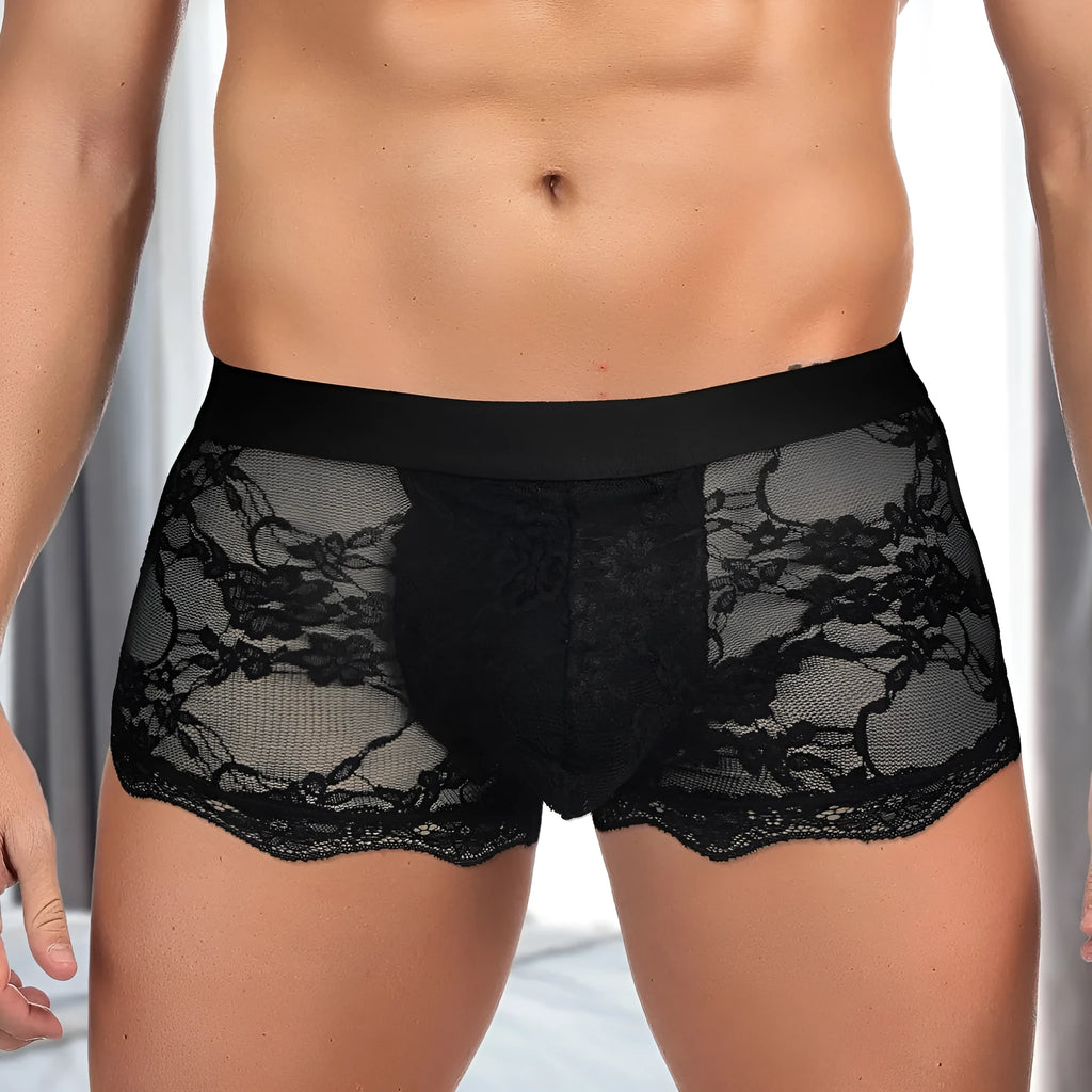 Men's black lace briefs with a hollow-out, see-through pattern laid flat.