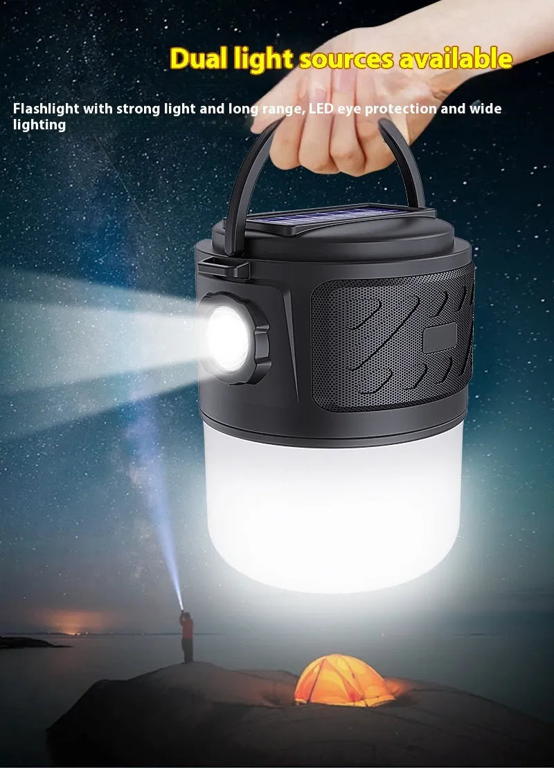 Portable solar camping lantern speaker with Bluetooth, LED light, USB rechargeable, black colour, on outdoor lawn