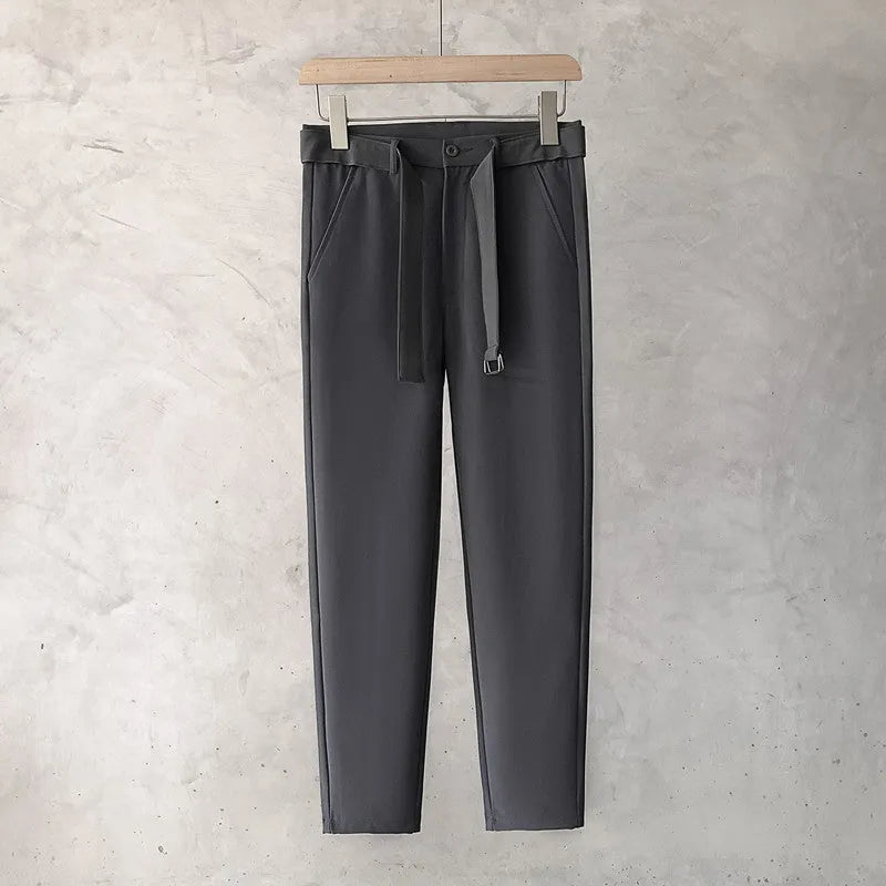 Boy wearing slim straight grey wool blend business casual trousers with a tapered fit