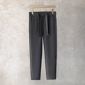 Boy wearing slim straight grey wool blend business casual trousers with a tapered fit