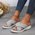 Women's black wedge peep-toe slippers with a thick rubber sole on a white background.