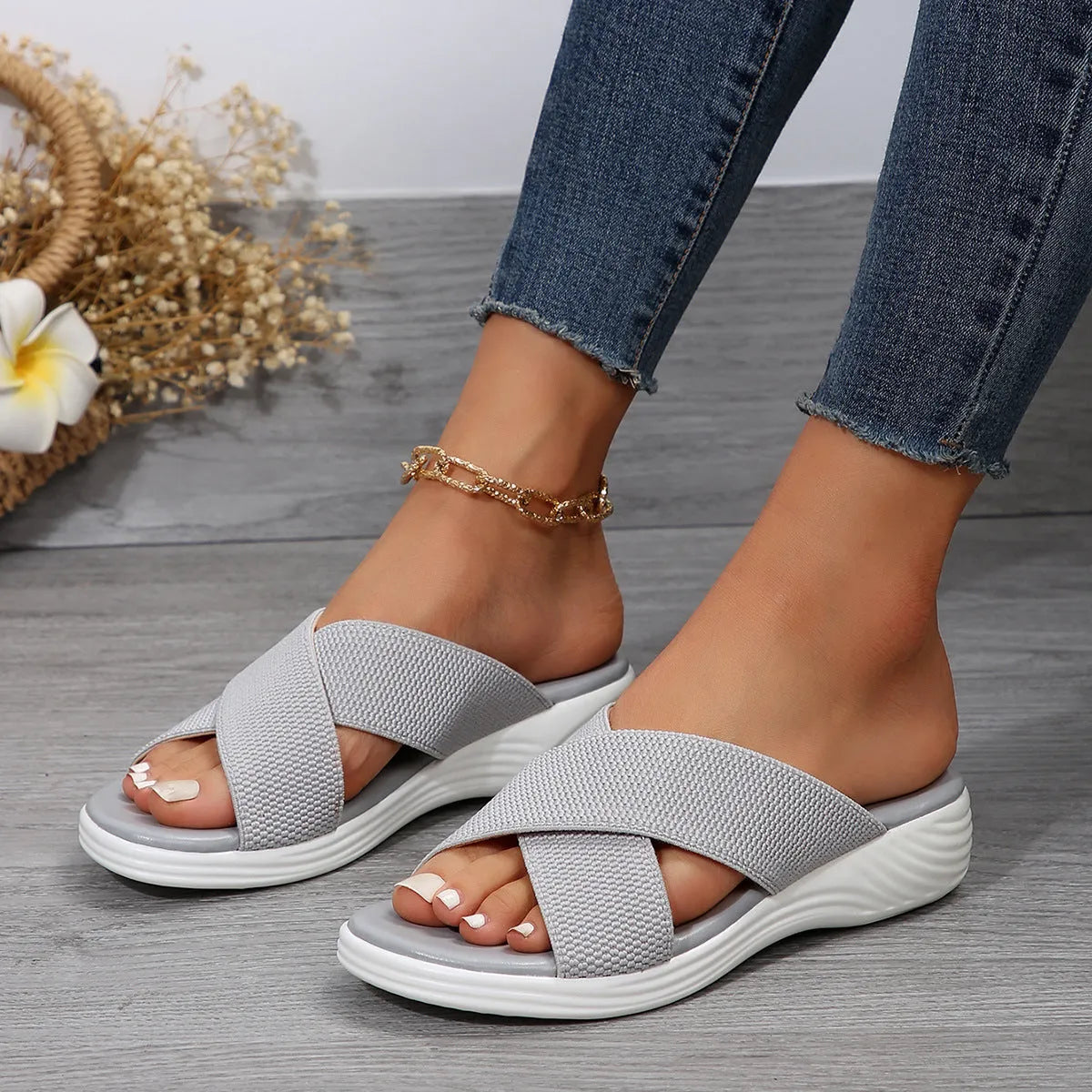 Women's black wedge peep-toe slippers with a thick rubber sole on a white background.