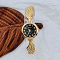 Women's stainless steel watch with round dial showing gold surface colour and vachette clasp