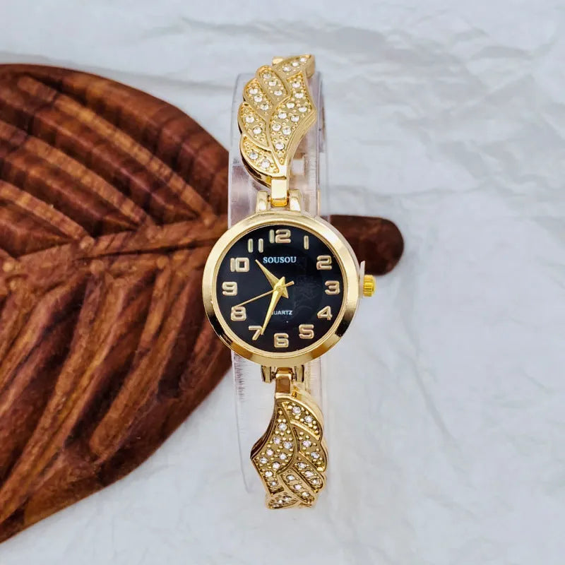 Women's stainless steel watch with round dial showing gold surface colour and vachette clasp
