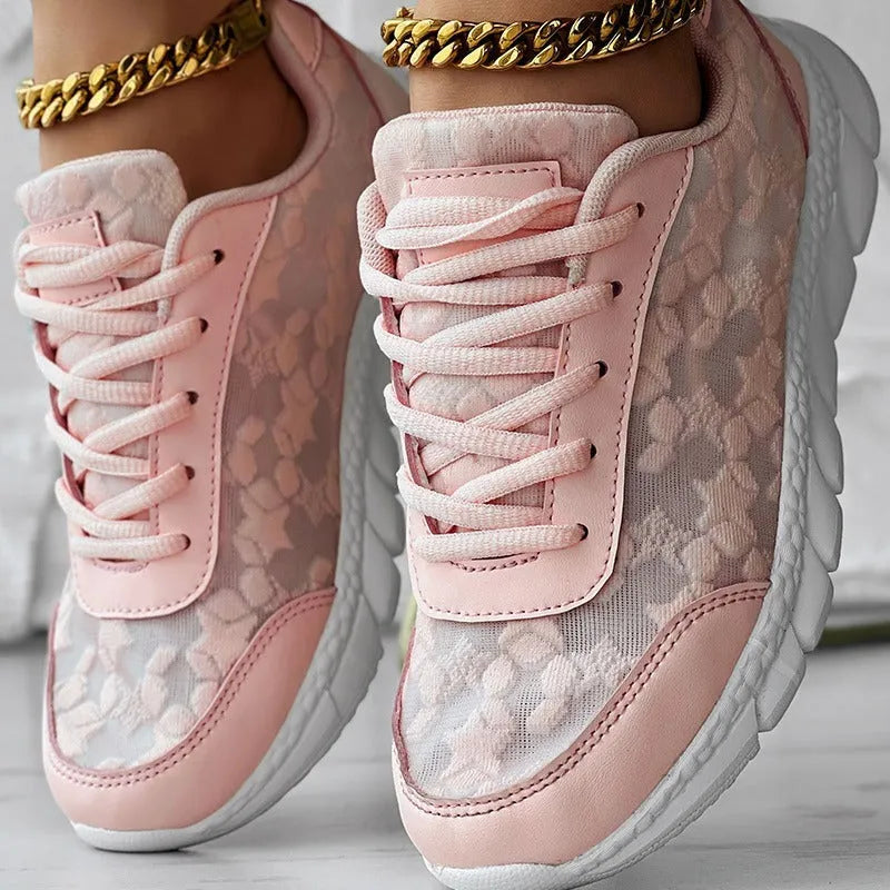 Women's casual canvas sports shoe in four colour options: white, black, blue, and pink, shown with a flat heel.