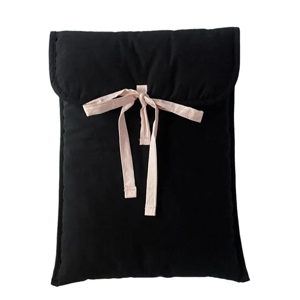 Black and white quilted women's laptop bag with striped pattern and a ballet-style bow.