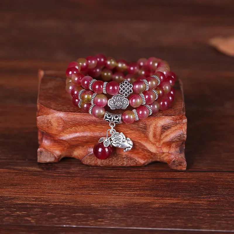 Watermelon crystal bracelet with Chinese knot design showing geometric natural stone beads