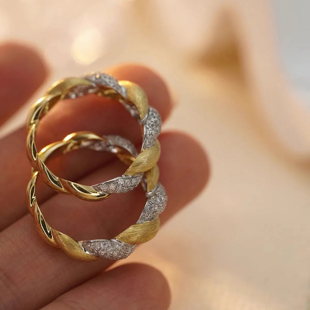 S925 sterling silver twist ring for women, yellow gold finish, geometric pointed band on white background