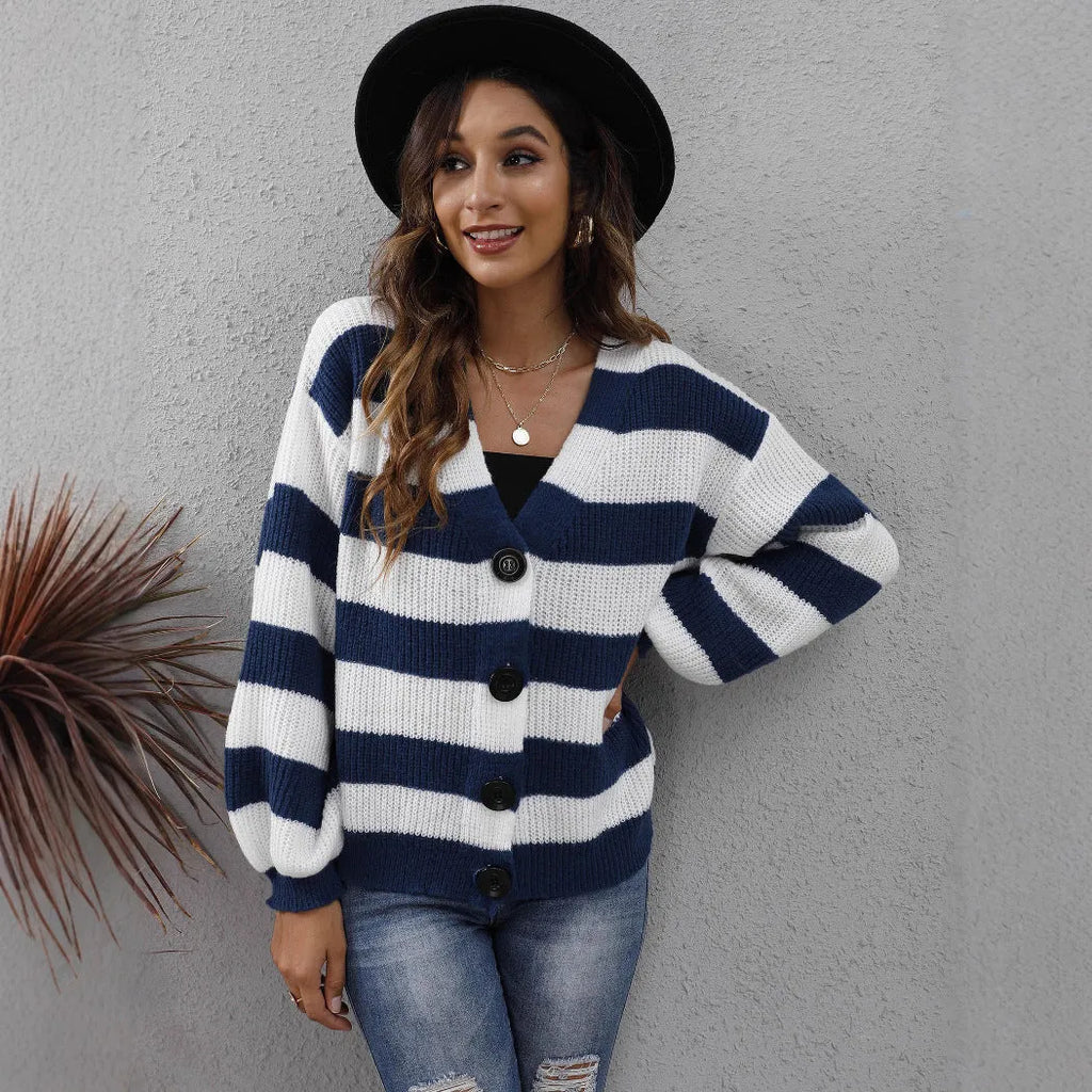 Blue striped women's cardigan with button front and deer plush textured fabric on a hanger.