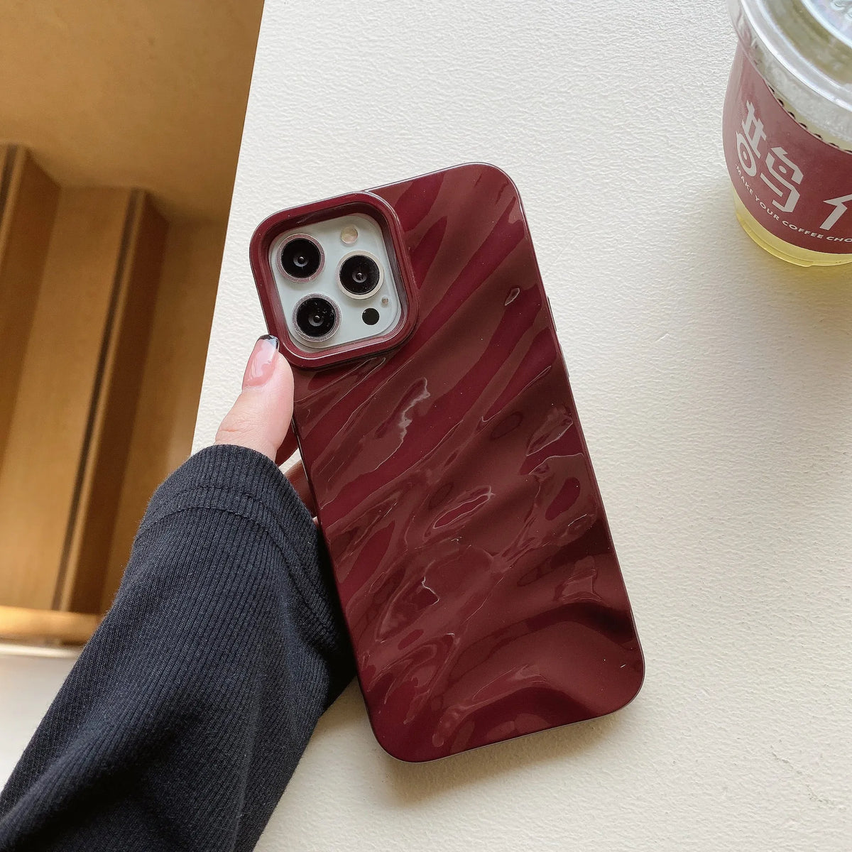 Soft solid colour wave pleated TPU protective case for Apple iPhone 17 series in burgundy on a white background.