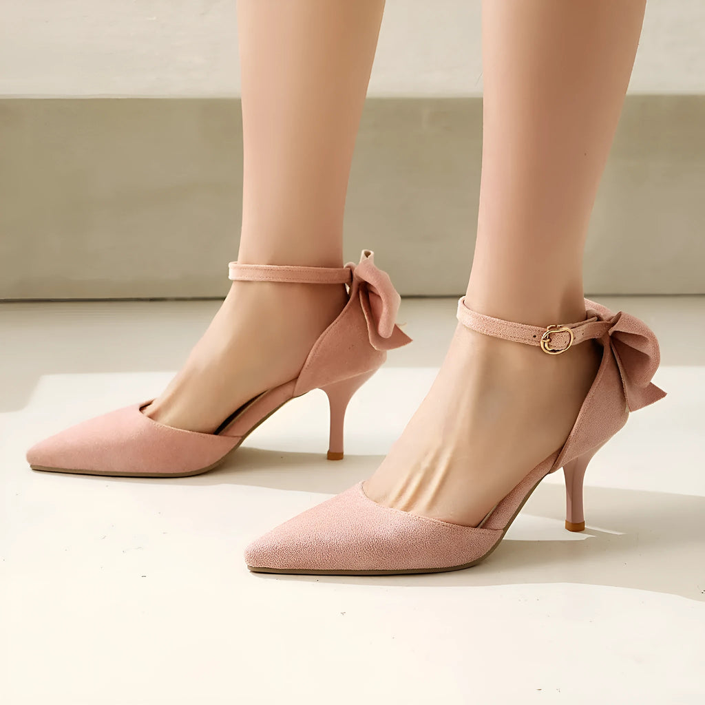 Black suede pointed-toe stiletto high heels with a bowknot detail and buckle fastening.