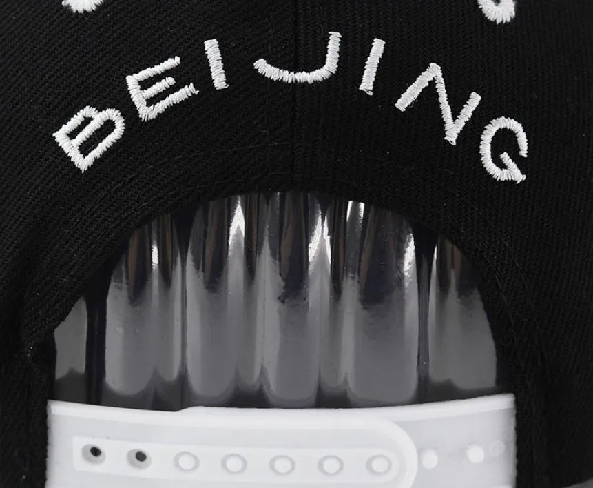Cotton baseball cap with embroidered letters in black and white colour options