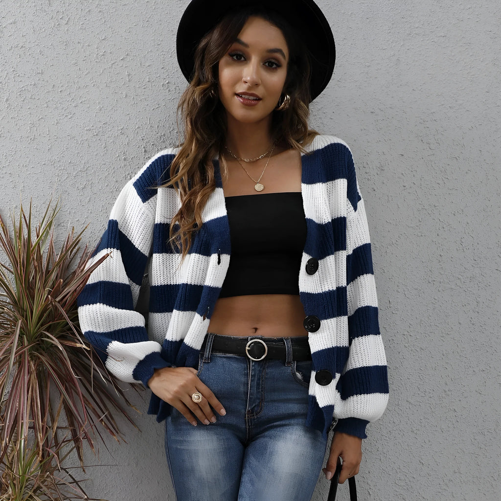 Blue striped women's cardigan with button front and deer plush textured fabric on a hanger.
