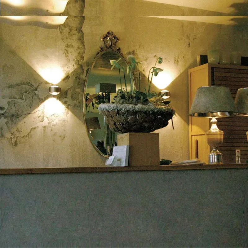Modern small wall lamp in chrome finish for bedside or hallway lighting