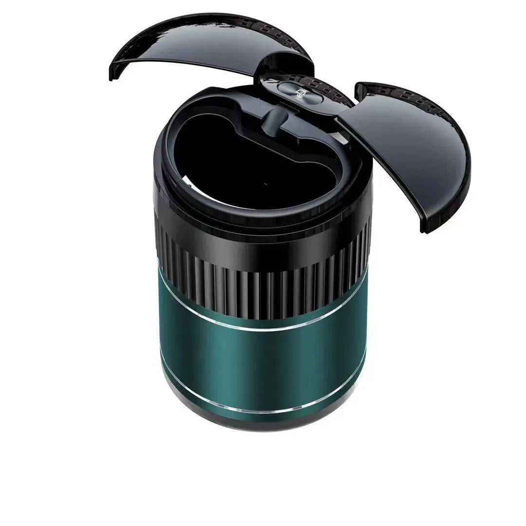 Smart black metal car ashtray with lid, showing compact size next to a charging cable.