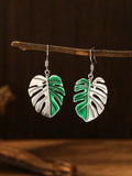 Silver alloy leaf-shaped drop earrings for women on white background