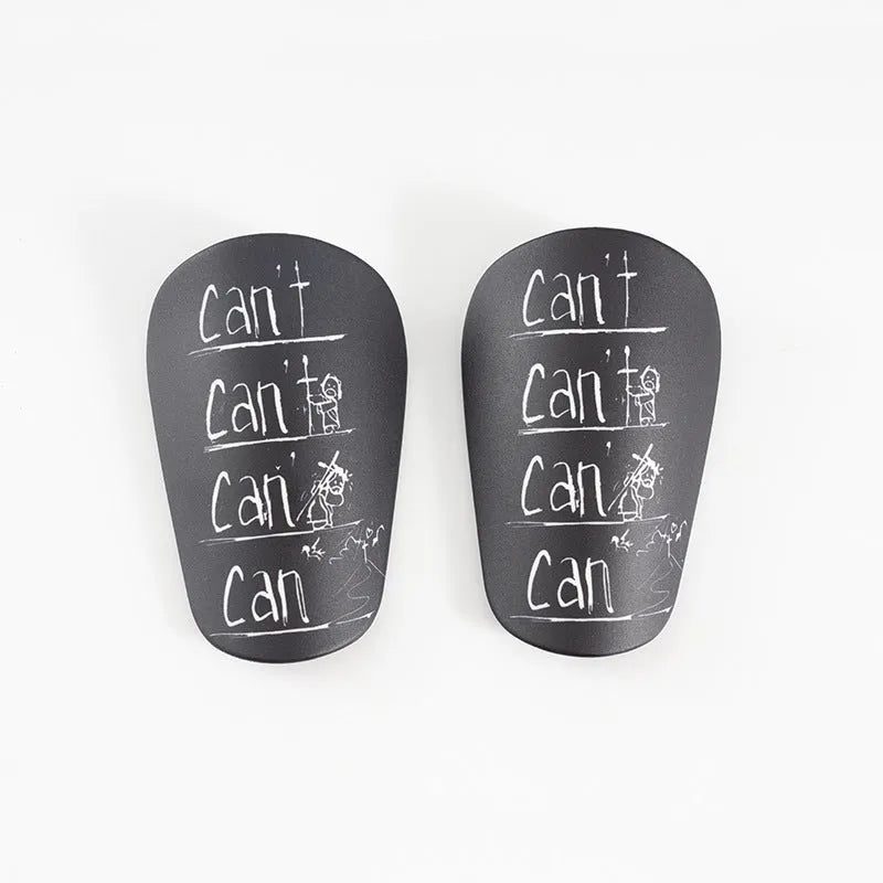 A pair of white and black PU football shin guards for S and XS sizes.