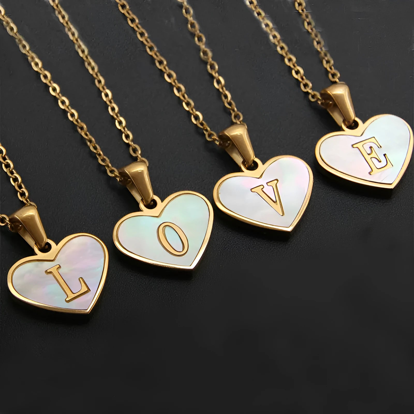 Gold-plated heart necklace with white shell pendant and initial personalisation on a stainless steel chain.