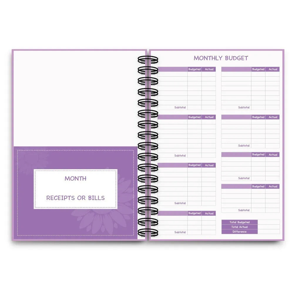 Purple coil-bound budget book with stickers and paper clips for monthly financial planning
