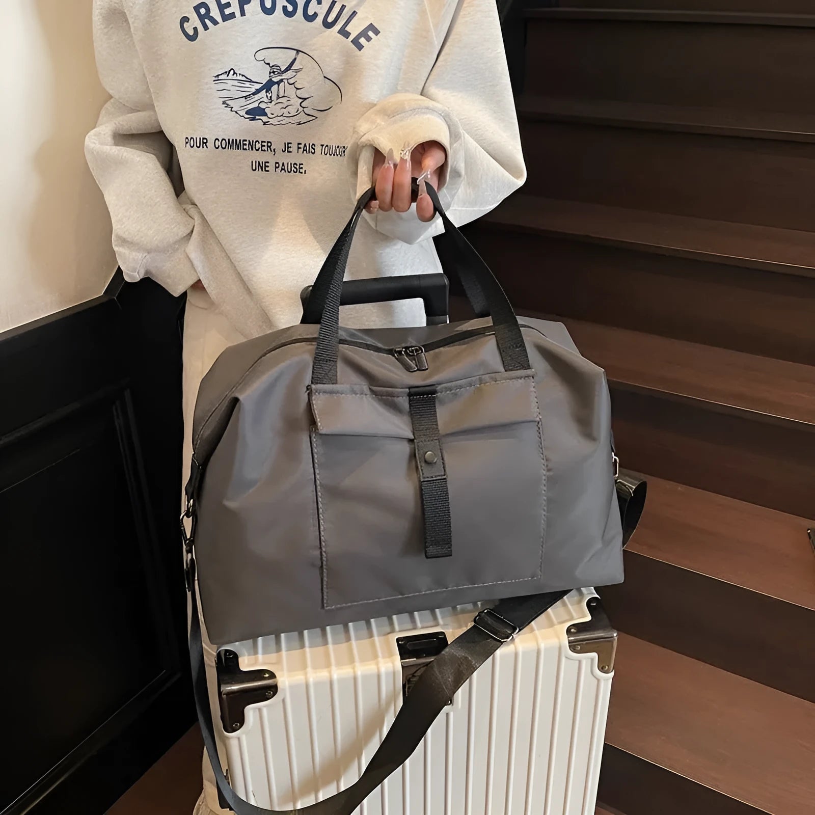 Grey one-shoulder travel bag with large 36-55 litre capacity and Oxford cloth construction