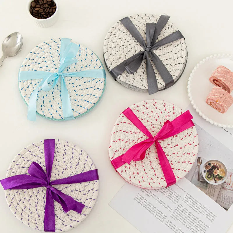 Three round cotton cord coasters in different colours showing 18cm diameter size