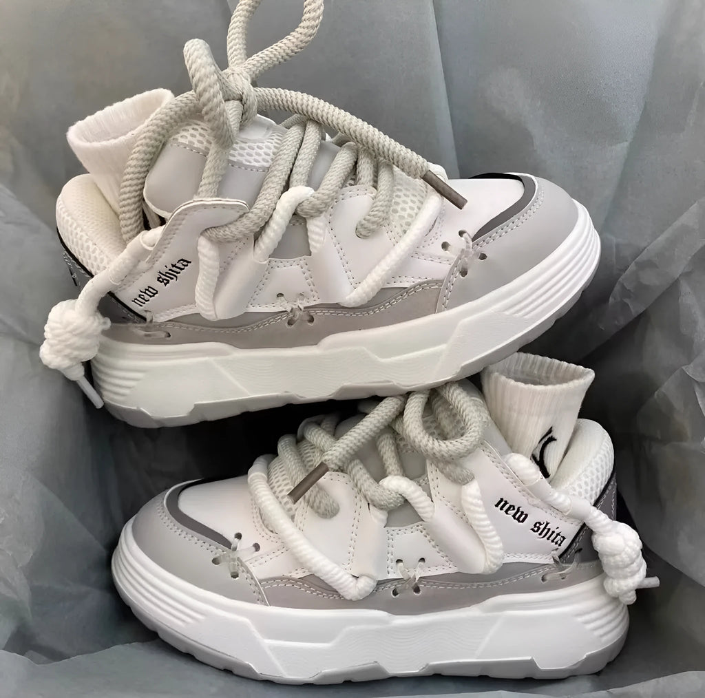 Women's grey retro chunky platform sneakers with a thick rubber sole and lace-up front.