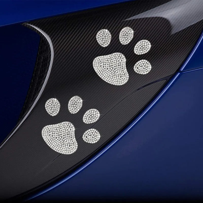 Glass car sticker with diamond-encrusted bear paw or butterfly design on white background.