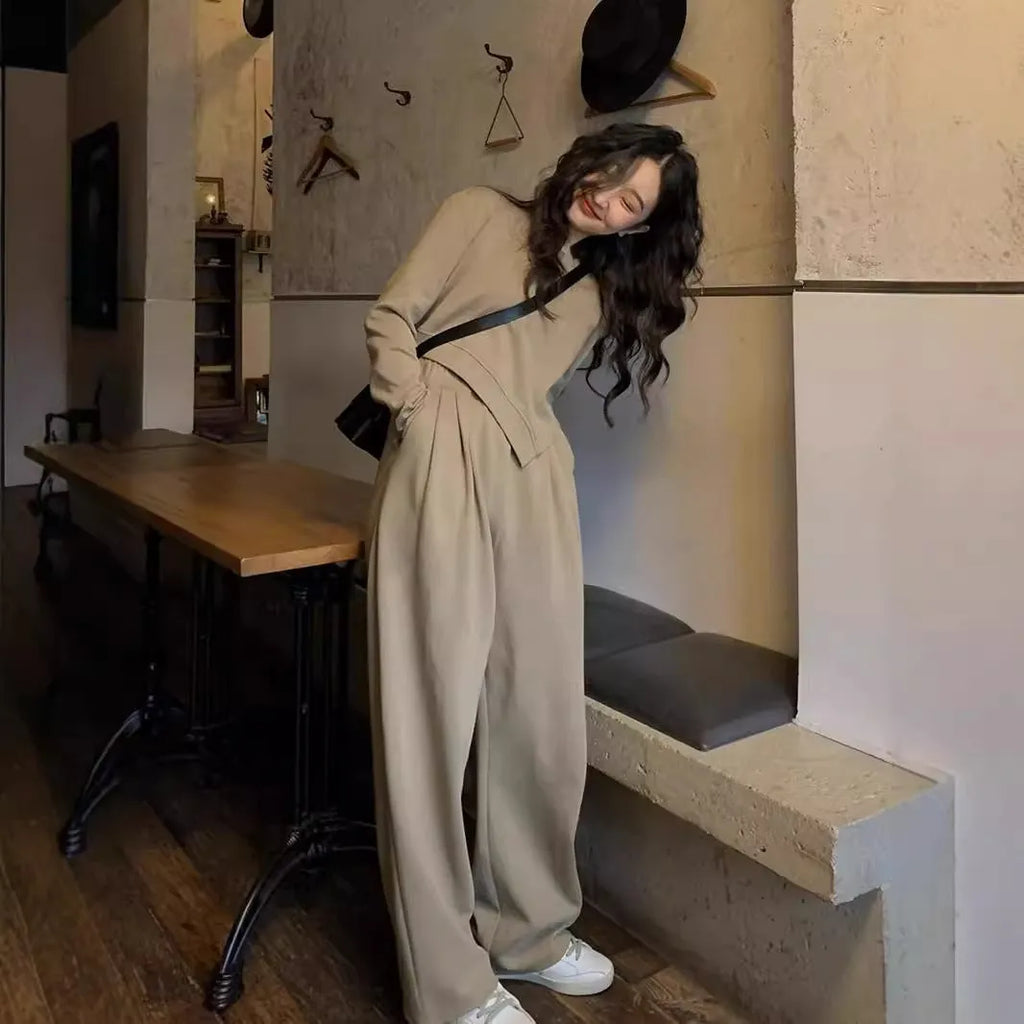 Women's khaki casual sports suit set with long sleeve top and trousers on a hanger