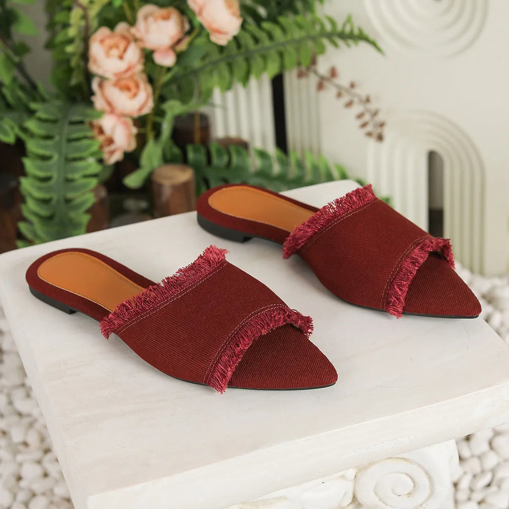 Women's denim flat slipper with tassel detail in apricot colour on a neutral background.