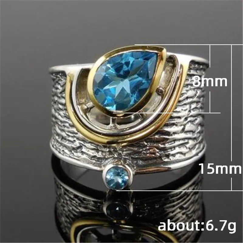 Close-up of a blue zircon and rhinestone drop-shaped ring in a Chinese style design.