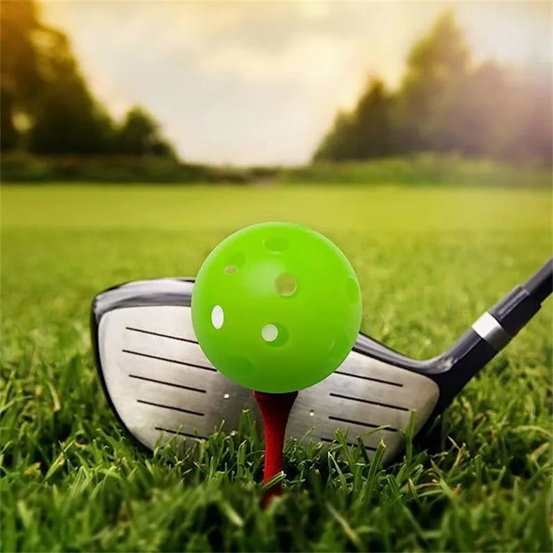 Multi-colour golf practice balls with 26-hole target design on green surface