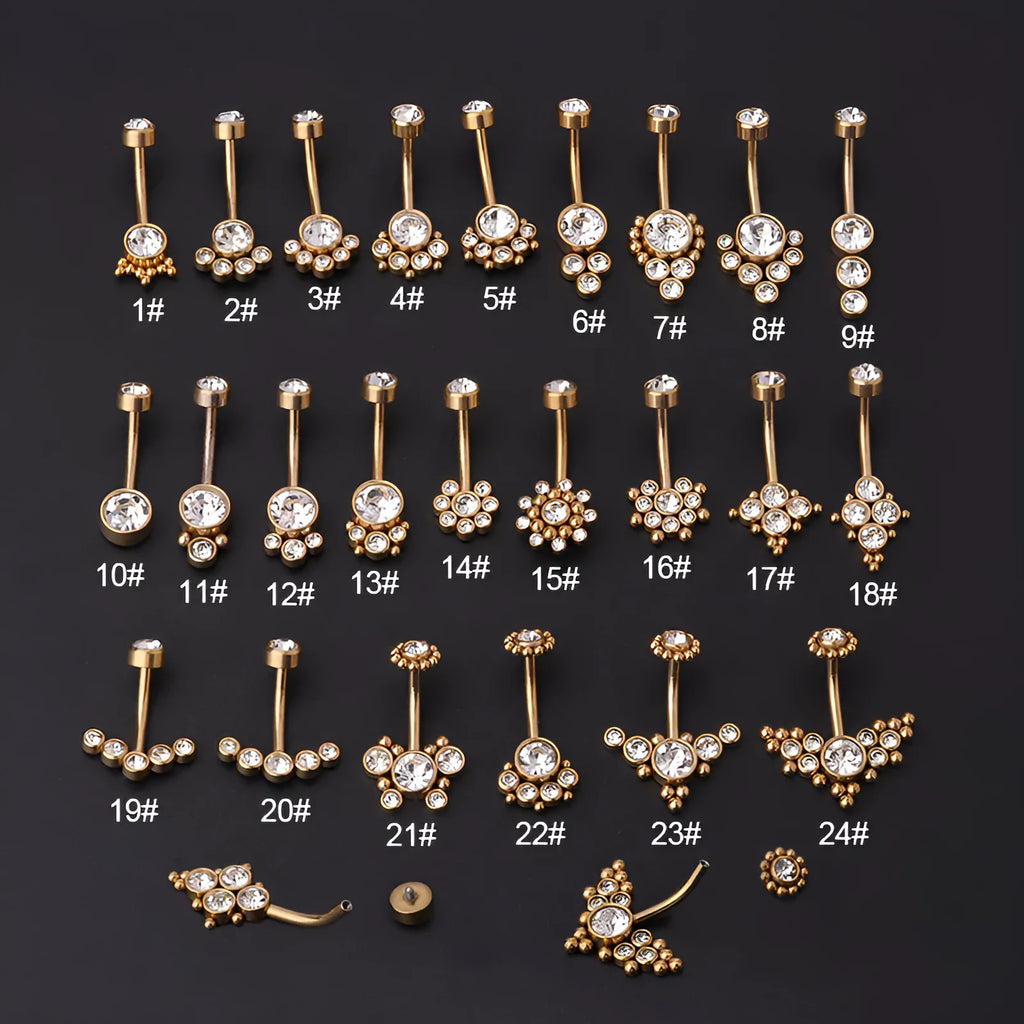 Gold stainless steel belly button ring with clear artificial gemstone inlay on white background
