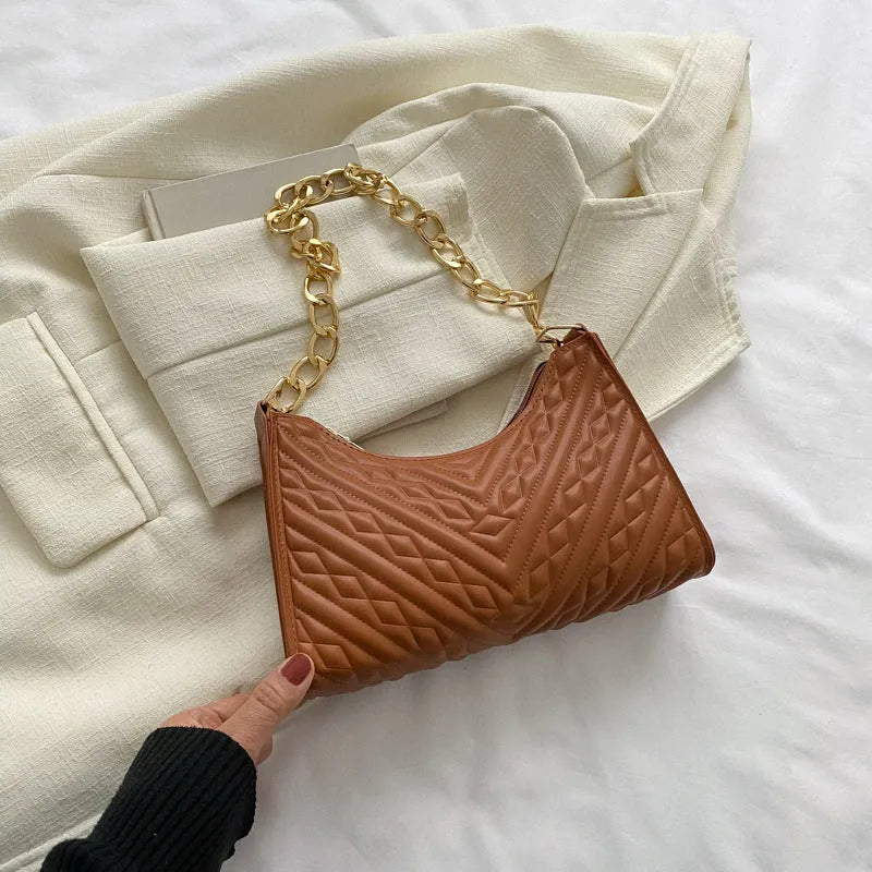 Brown pleated chain shoulder bag with soft handle and adjustable strap showing sewing line detailing