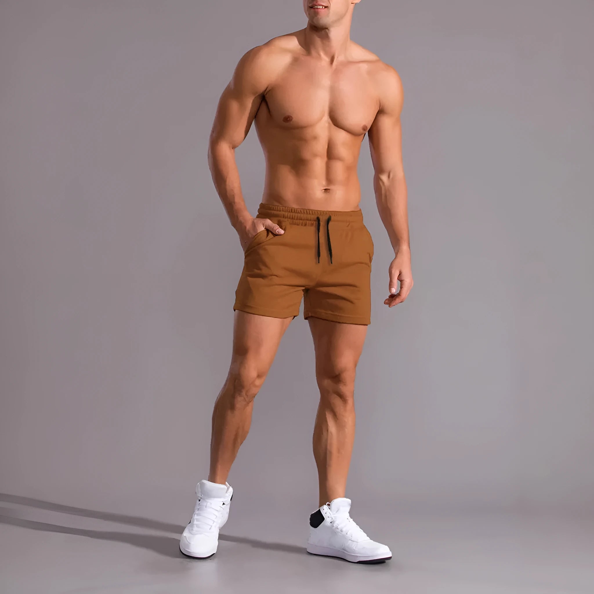 Three pairs of men's solid colour shorts in black, khaki, and light brown with drawstring waistbands