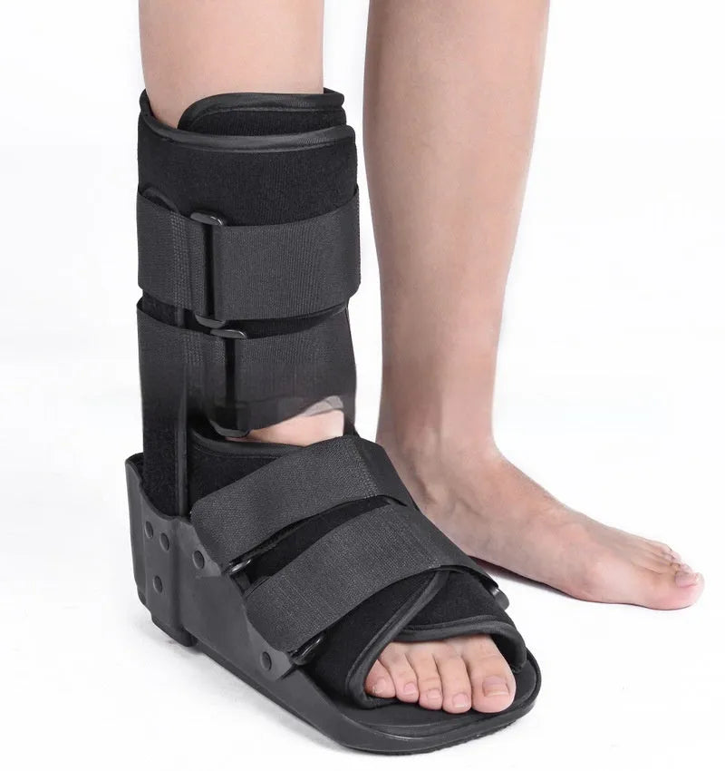 Black adjustable Achilles tendon rehabilitation boot with aluminium struts, shown on a foot.