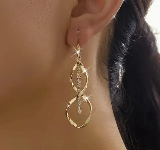Gold electroplated spiral design alloy earrings with geometric elliptical shape for women