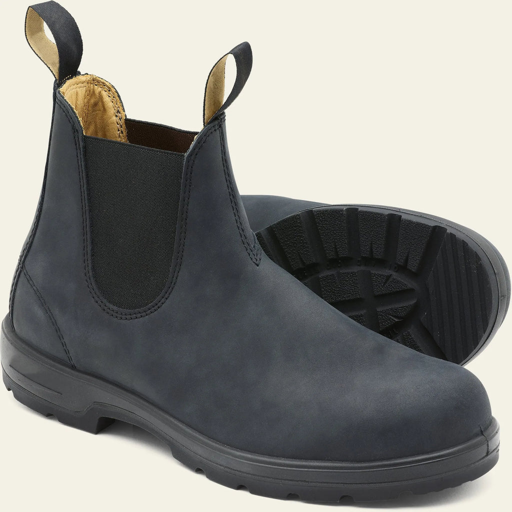 Vintage brown Chelsea boots with frosted PU upper and round toe on wooden floor