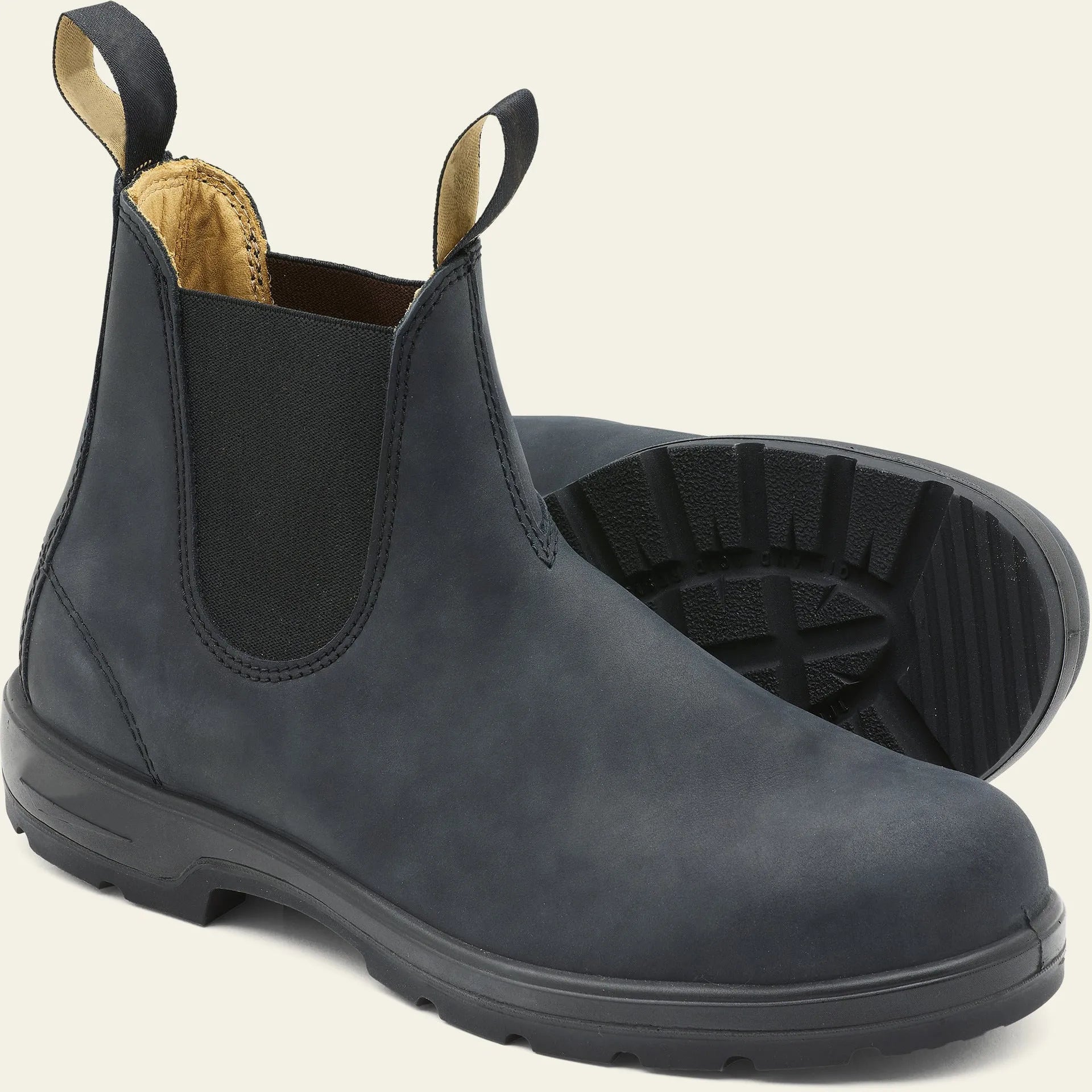 Vintage brown Chelsea boots with frosted PU upper and round toe on wooden floor