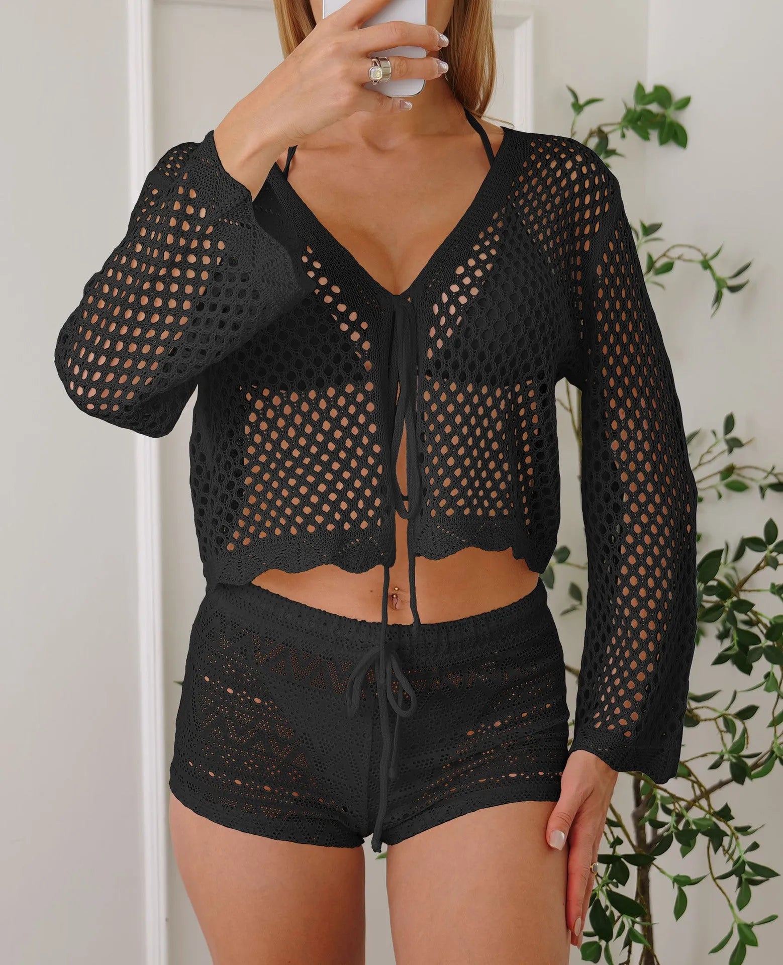 Women's apricot hollow woven cardigan blouse with bell sleeves laid flat