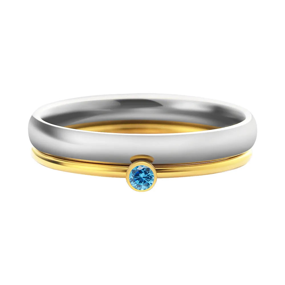 Geometric titanium steel ring with a raised December colour birthstone setting on a gold-toned band.