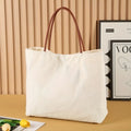 Canvas tote bag with side gussets in beige white colour, shown with handles extended