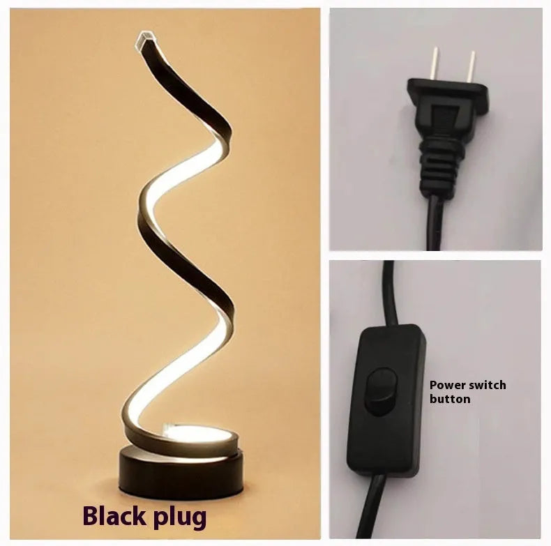 Black and white minimalist LED table lamp with aluminium shade on a desk.