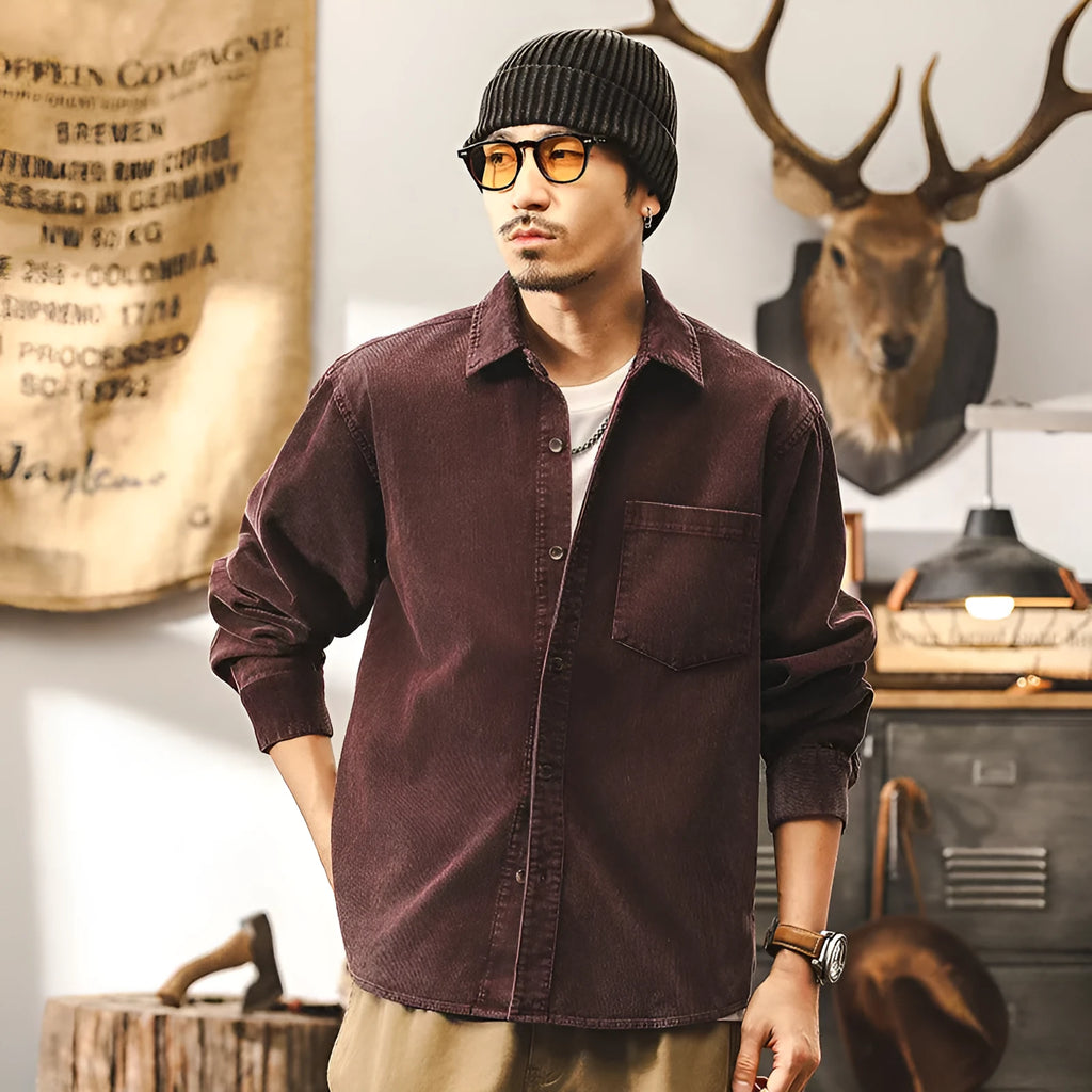 Men's loose-fit long-sleeved corduroy shirt jacket in black or red, showing textured combed cotton fabric.