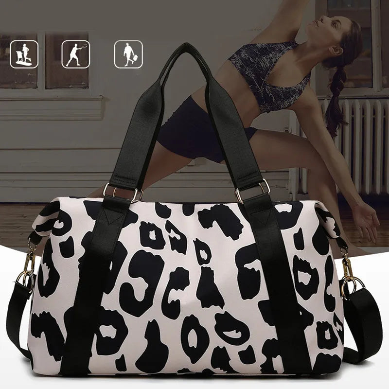Women's large travel duffel bag with cow pattern, black, showing zippered main compartment and soft handle